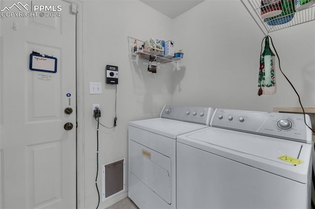 clothes washing area featuring washing machine and dryer