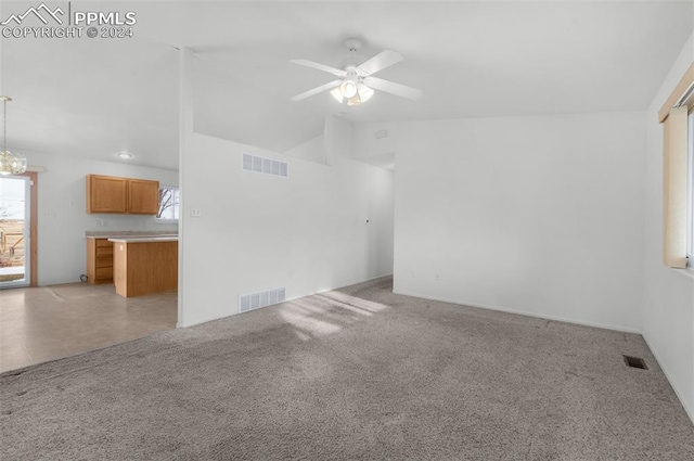 unfurnished living room featuring light colored carpet, ceiling fan, and lofted ceiling