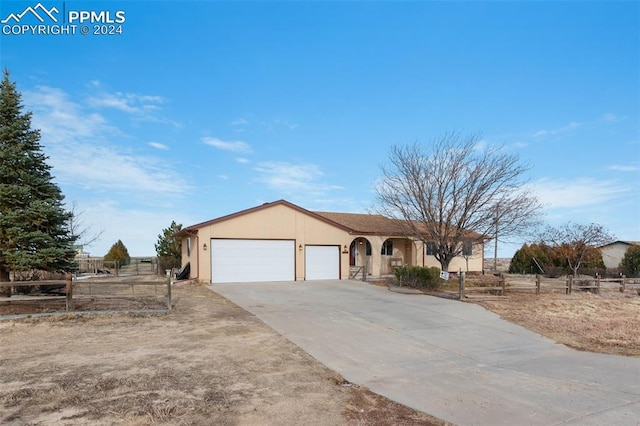 ranch-style house featuring a garage