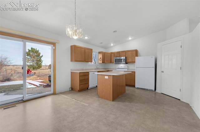 kitchen featuring pendant lighting, white appliances, vaulted ceiling, a notable chandelier, and a kitchen island