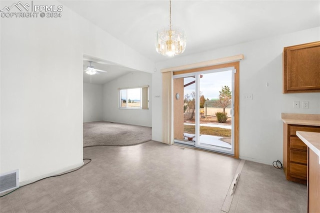 interior space featuring ceiling fan with notable chandelier and lofted ceiling