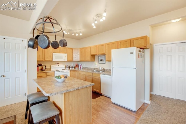 kitchen featuring white appliances, light hardwood / wood-style flooring, light brown cabinetry, and sink