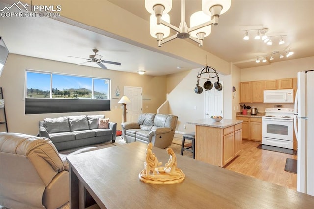 kitchen with white appliances, light brown cabinetry, light hardwood / wood-style flooring, and hanging light fixtures