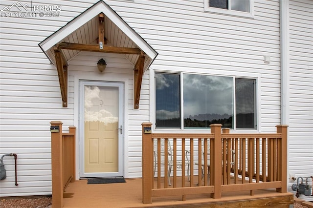 view of exterior entry with a wooden deck