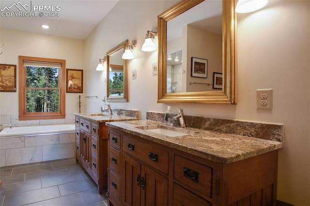 bathroom featuring tile patterned flooring, vanity, and a relaxing tiled tub