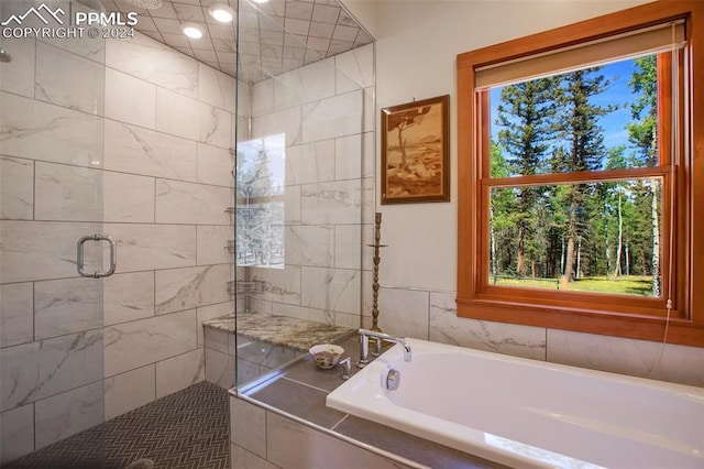 bathroom featuring shower with separate bathtub