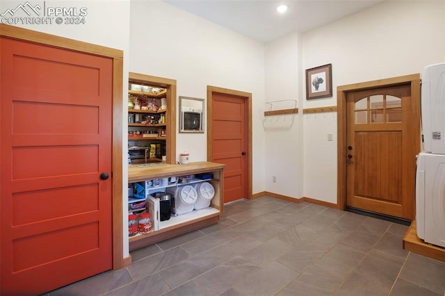 entryway with stacked washer / drying machine