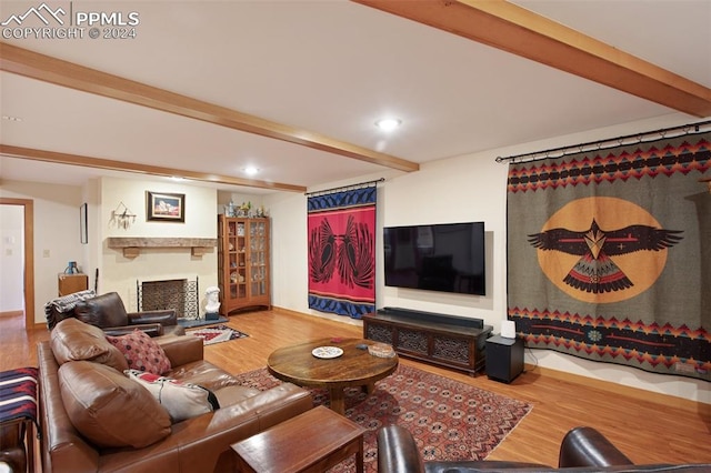 living room with beamed ceiling and wood-type flooring