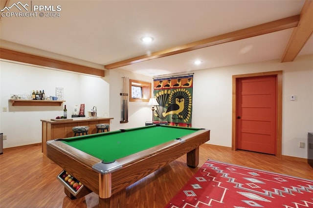 rec room featuring beamed ceiling, hardwood / wood-style flooring, bar, and billiards