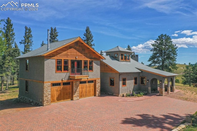 view of front of home featuring a balcony and a garage