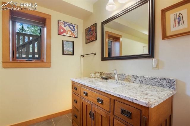 bathroom featuring tile patterned flooring and vanity