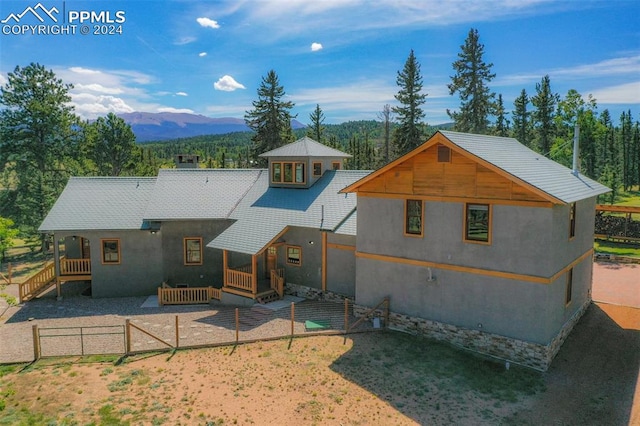 rear view of house featuring a mountain view