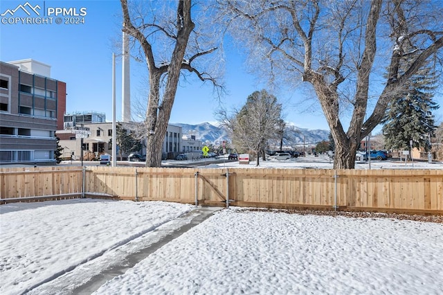 snowy yard featuring a mountain view