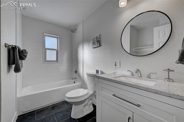 full bathroom with tile patterned flooring, tiled shower / bath combo, toilet, and vanity