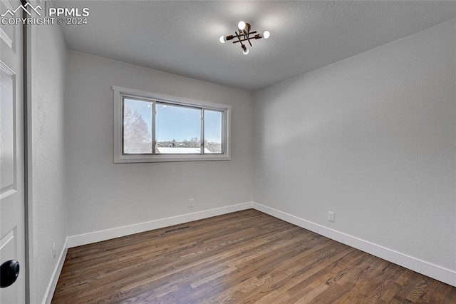 unfurnished room with dark wood-type flooring