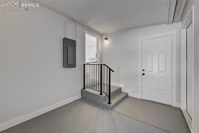 interior space featuring electric panel and concrete floors