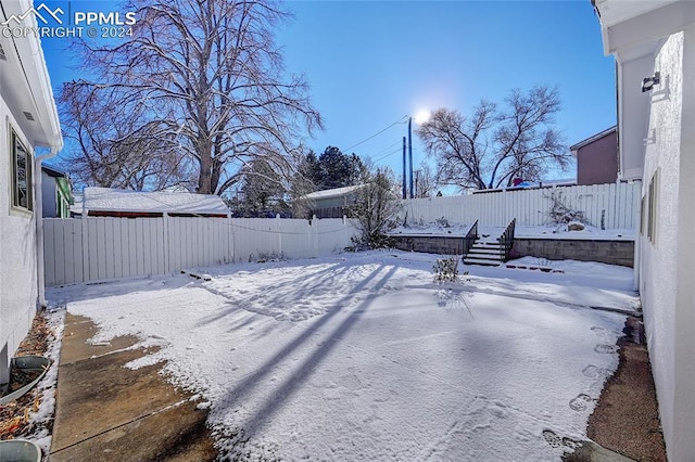 view of yard layered in snow