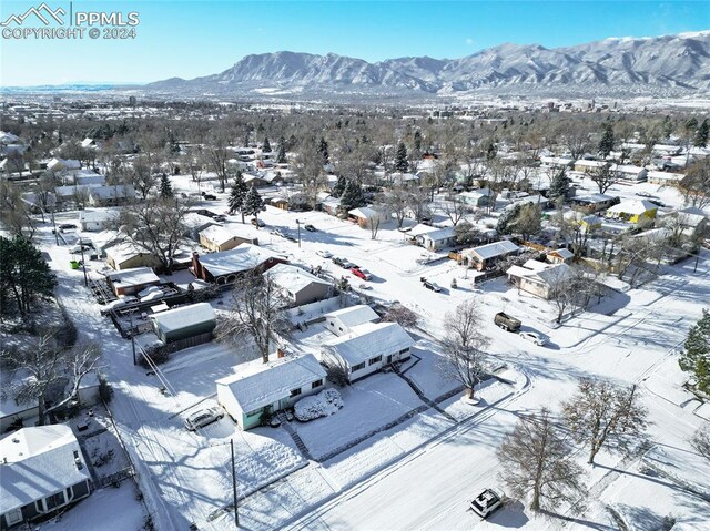 snowy aerial view with a mountain view