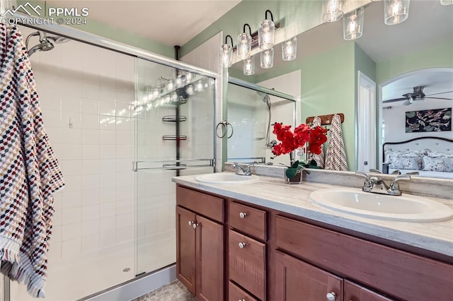 bathroom featuring an enclosed shower, vanity, and ceiling fan