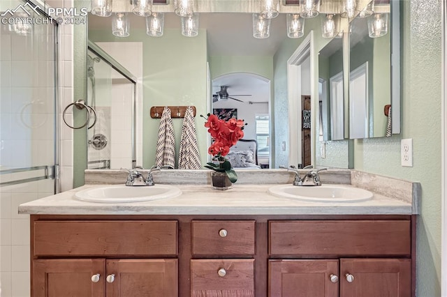 bathroom featuring vanity, a shower with door, and ceiling fan