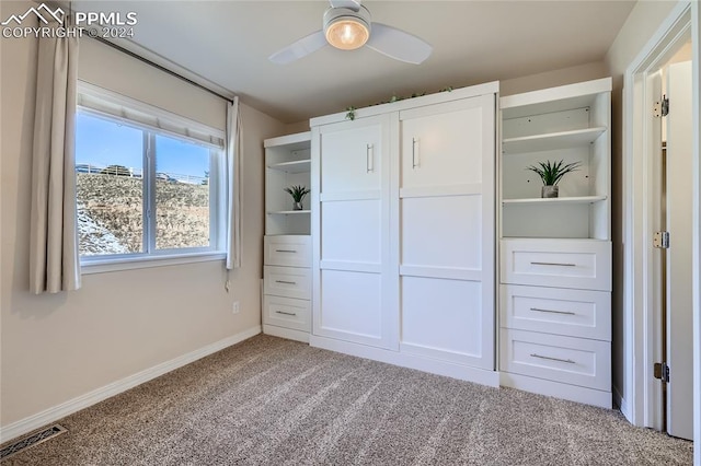 unfurnished bedroom featuring light carpet, a closet, and ceiling fan