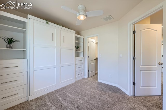 unfurnished bedroom with ceiling fan, light carpet, and a closet