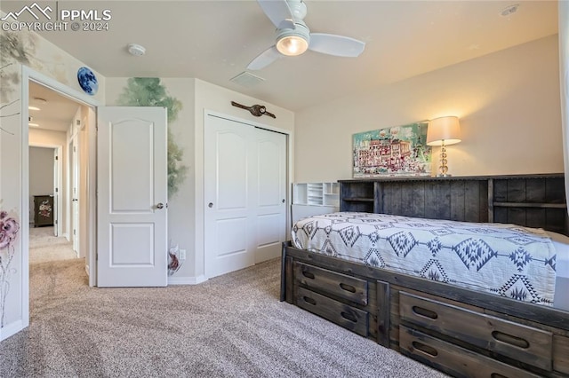 carpeted bedroom featuring ceiling fan and a closet