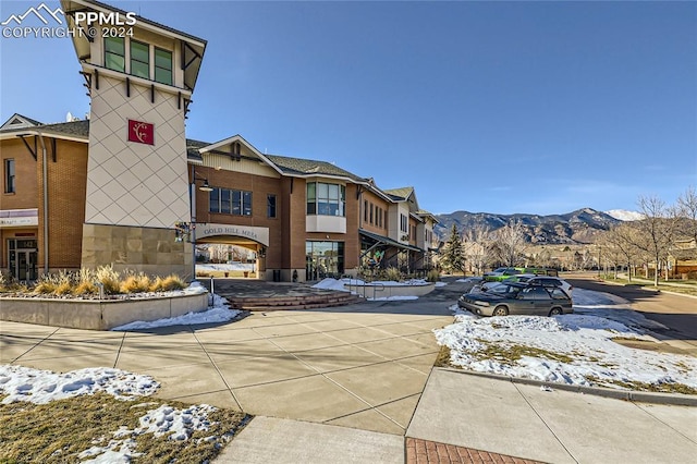 snow covered property with a mountain view