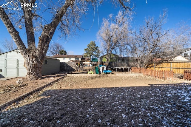 view of yard featuring a playground and a trampoline