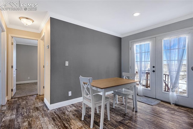 dining space featuring crown molding, dark wood-type flooring, and french doors