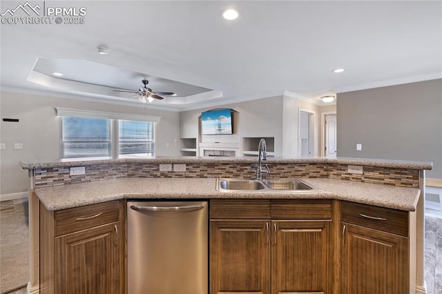 kitchen featuring sink, crown molding, dishwasher, a raised ceiling, and decorative backsplash