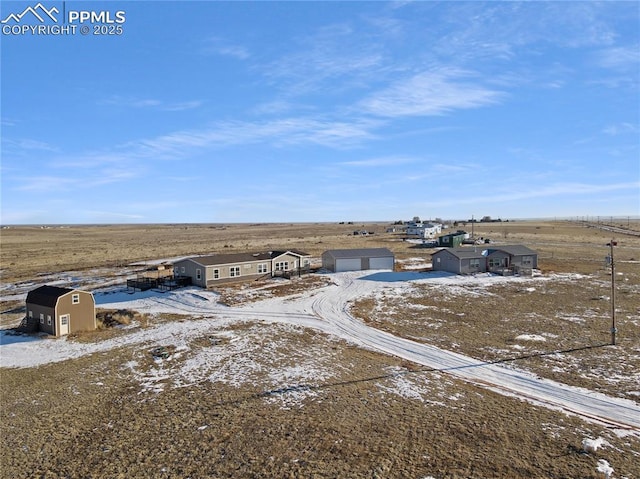 snowy aerial view featuring a rural view