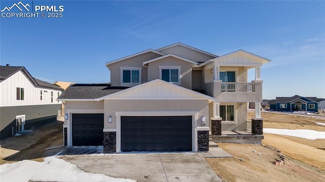 779 Old Grotto Dr, Monument, CO 80132 - view of front facade featuring a balcony, an attached garage, stone siding, and driveway