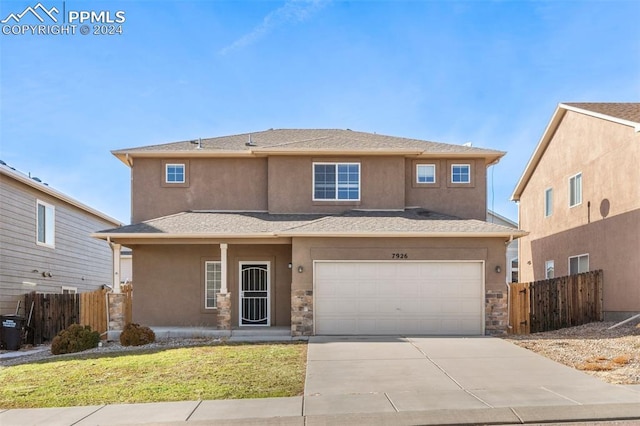 view of front of house featuring a garage and a front yard