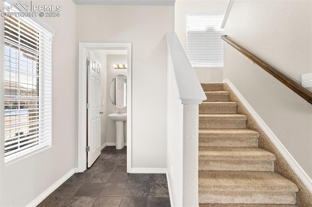 stairway featuring a wealth of natural light and sink