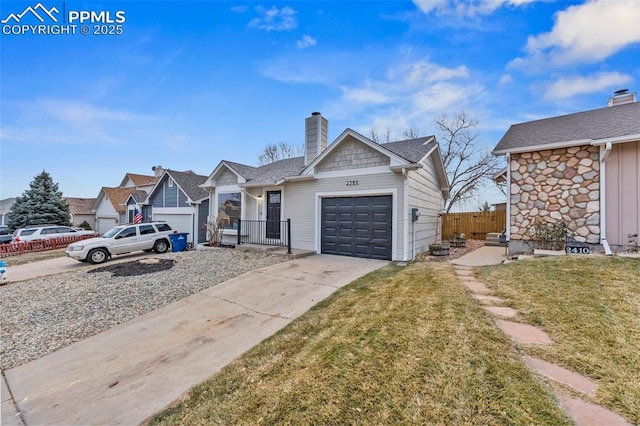 view of front of home with a garage and a front lawn