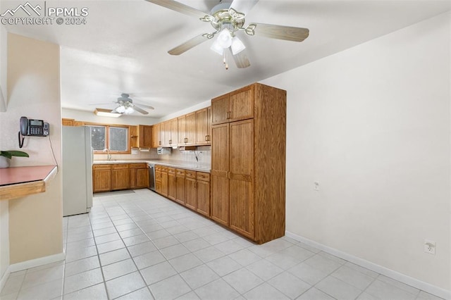 kitchen with dishwasher, white refrigerator, sink, ceiling fan, and light tile patterned floors