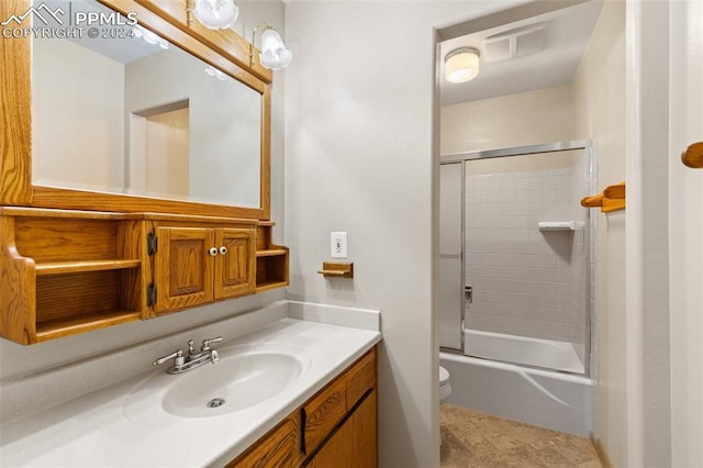 full bathroom with vanity, toilet, and shower / bath combination with glass door