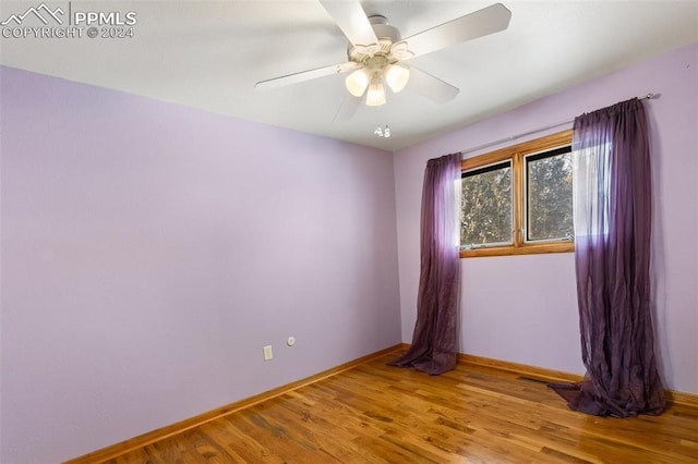 empty room with ceiling fan and wood-type flooring