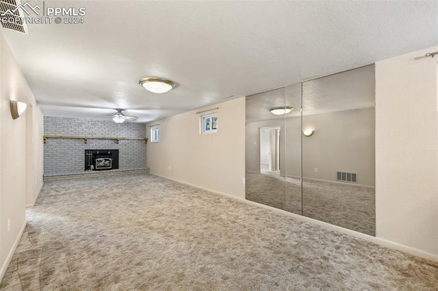 basement featuring carpet flooring and ceiling fan