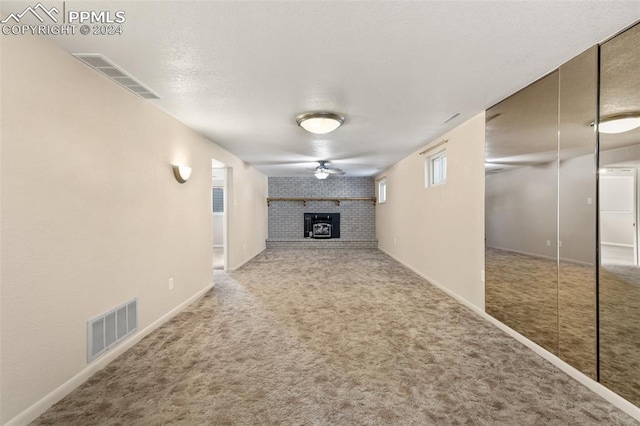 unfurnished living room featuring carpet floors and a wood stove