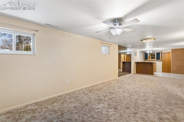 interior space with ceiling fan and carpet