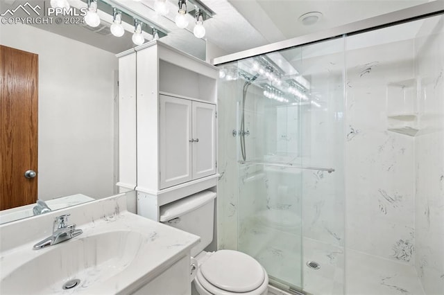 bathroom with vanity, toilet, and walk in shower