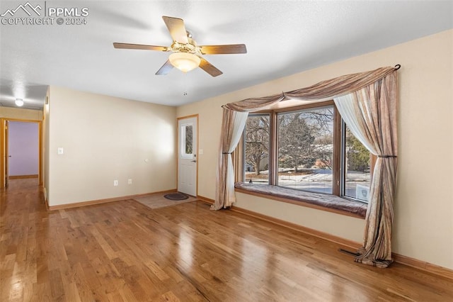 interior space with light hardwood / wood-style floors and ceiling fan