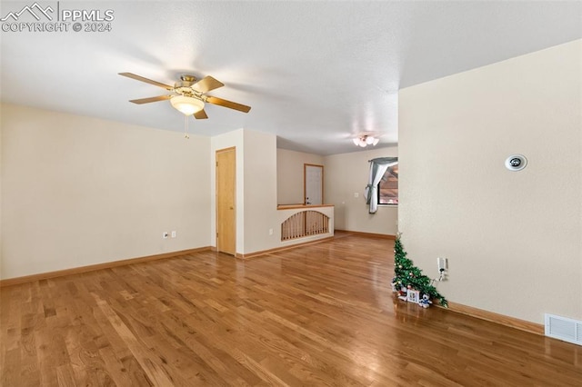 unfurnished living room featuring wood-type flooring and ceiling fan