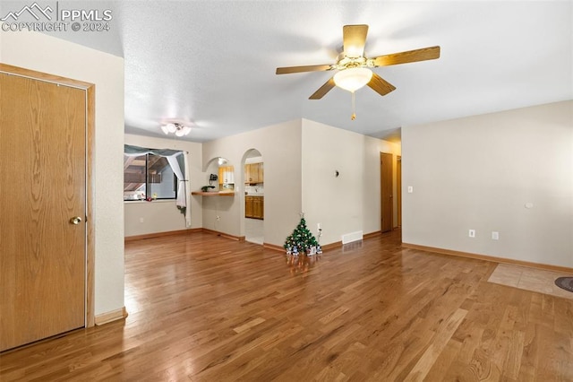 unfurnished living room featuring hardwood / wood-style floors and ceiling fan