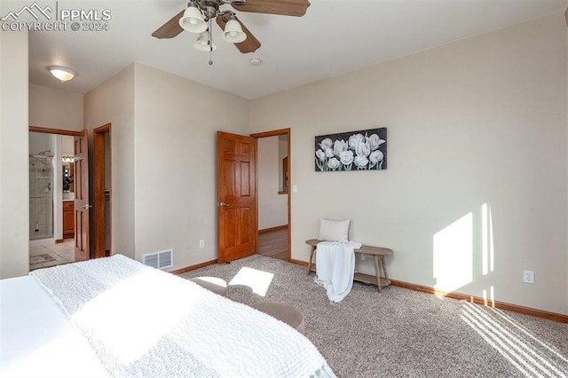 bedroom featuring light carpet, ensuite bath, and ceiling fan