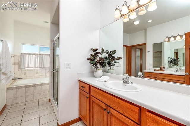 bathroom with tile patterned flooring, shower with separate bathtub, and vanity