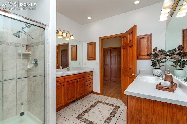 bathroom with wood-type flooring, vanity, and walk in shower