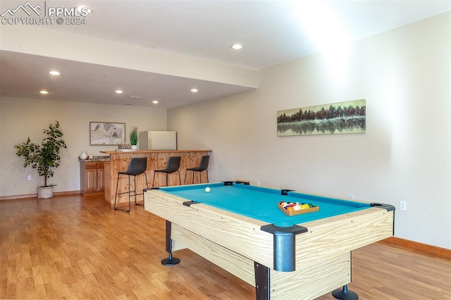 playroom with bar area, light hardwood / wood-style flooring, and pool table